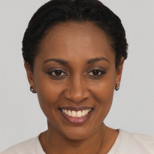 Joyful black young-adult female with short  black hair and brown eyes