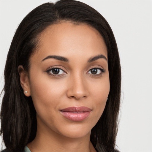 Joyful latino young-adult female with long  brown hair and brown eyes