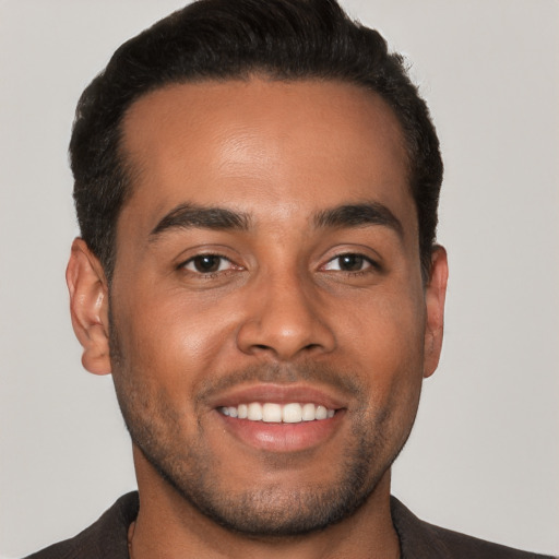 Joyful white young-adult male with short  black hair and brown eyes