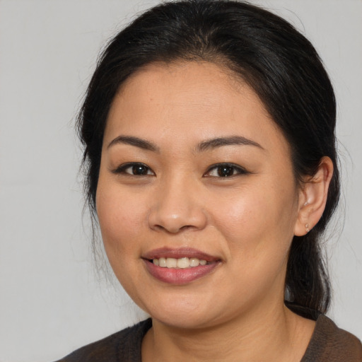 Joyful asian young-adult female with medium  brown hair and brown eyes