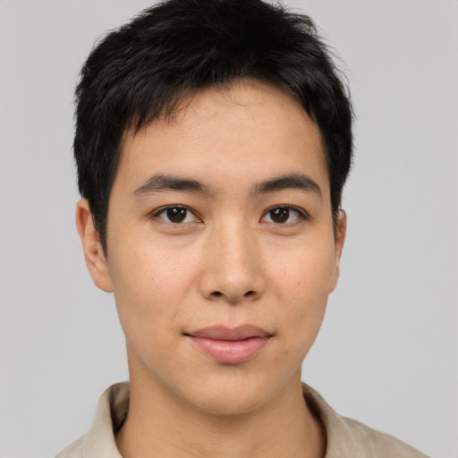 Joyful asian young-adult male with short  brown hair and brown eyes