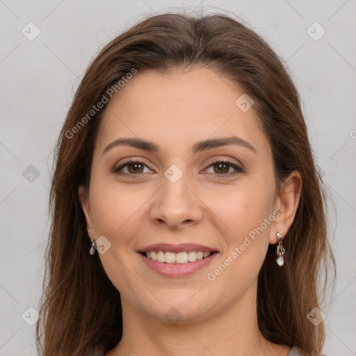 Joyful white young-adult female with long  brown hair and brown eyes