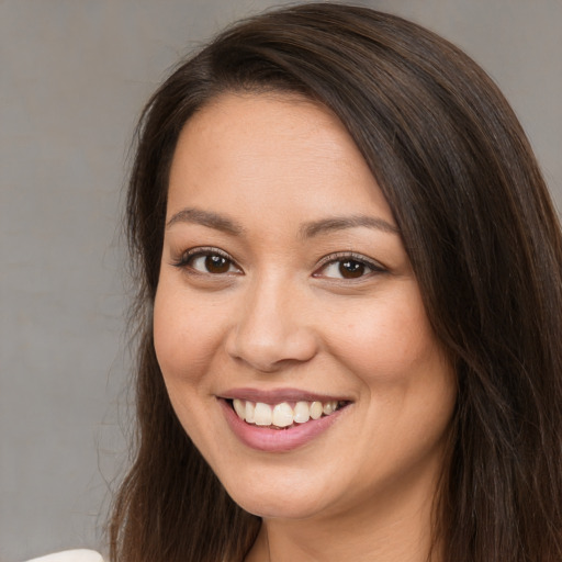 Joyful white young-adult female with long  brown hair and brown eyes
