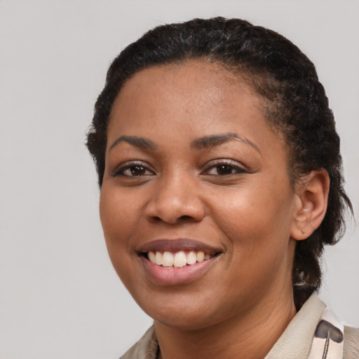 Joyful latino young-adult female with short  black hair and brown eyes