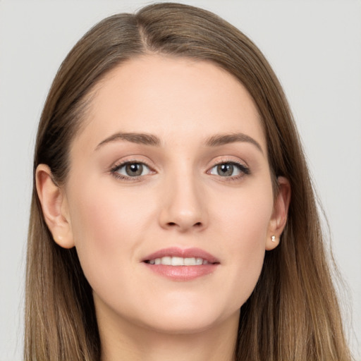 Joyful white young-adult female with long  brown hair and grey eyes