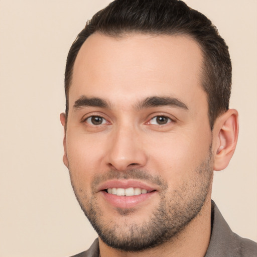 Joyful white young-adult male with short  black hair and brown eyes