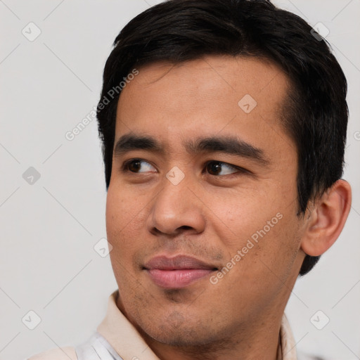 Joyful asian young-adult male with short  black hair and brown eyes