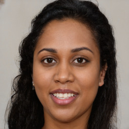 Joyful latino young-adult female with long  brown hair and brown eyes