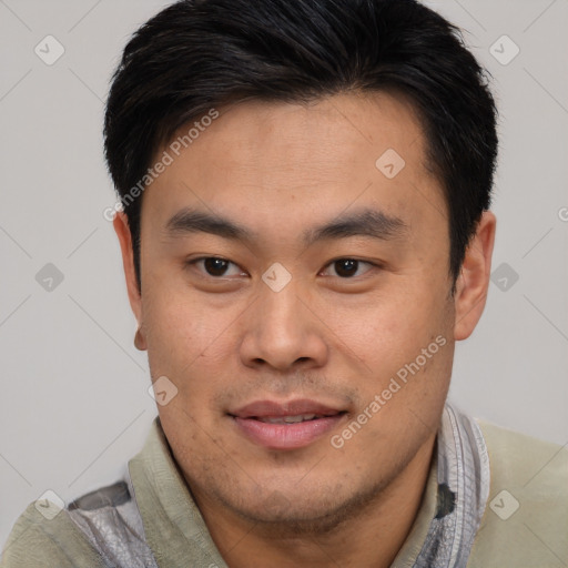 Joyful asian young-adult male with short  brown hair and brown eyes