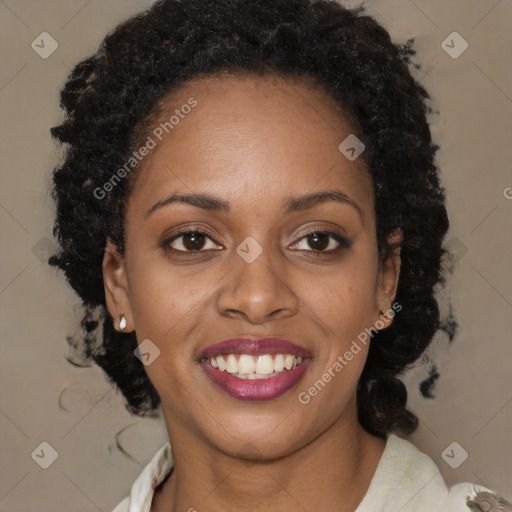 Joyful black young-adult female with long  brown hair and brown eyes