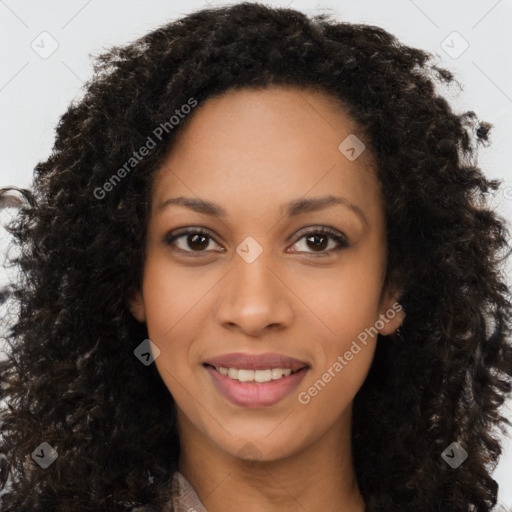 Joyful black young-adult female with long  brown hair and brown eyes