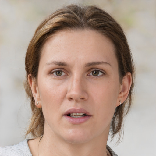 Joyful white adult female with medium  brown hair and grey eyes