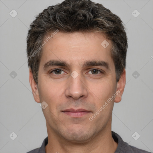 Joyful white young-adult male with short  black hair and brown eyes