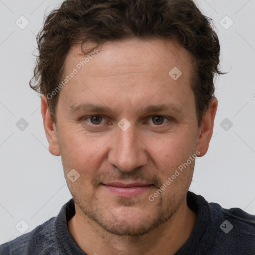 Joyful white adult male with short  brown hair and grey eyes