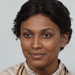 Joyful black adult female with short  brown hair and brown eyes