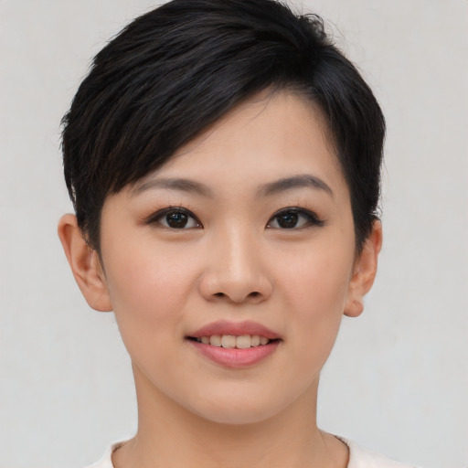 Joyful asian young-adult female with short  brown hair and brown eyes