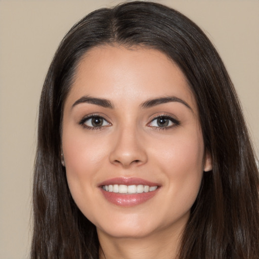 Joyful white young-adult female with long  black hair and brown eyes