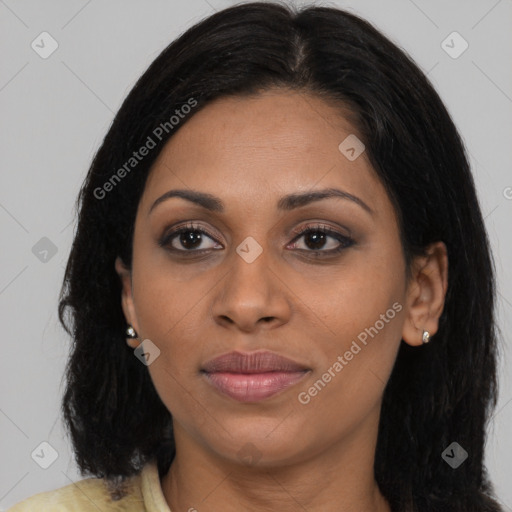 Joyful black young-adult female with long  brown hair and brown eyes