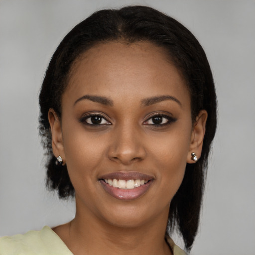 Joyful black young-adult female with medium  brown hair and brown eyes