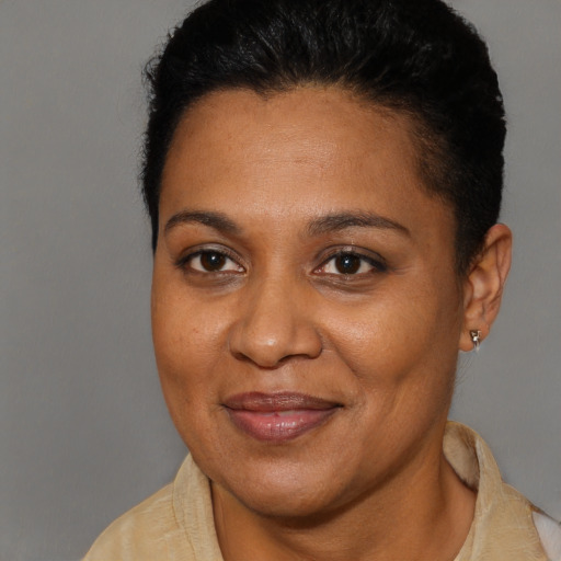 Joyful black adult female with short  brown hair and brown eyes