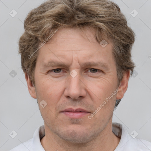 Joyful white adult male with short  brown hair and grey eyes