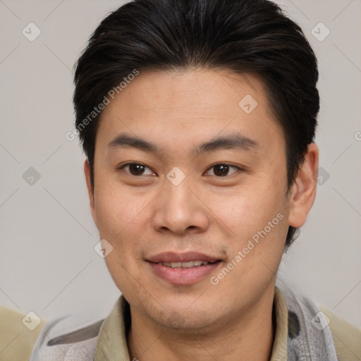 Joyful asian young-adult male with short  brown hair and brown eyes