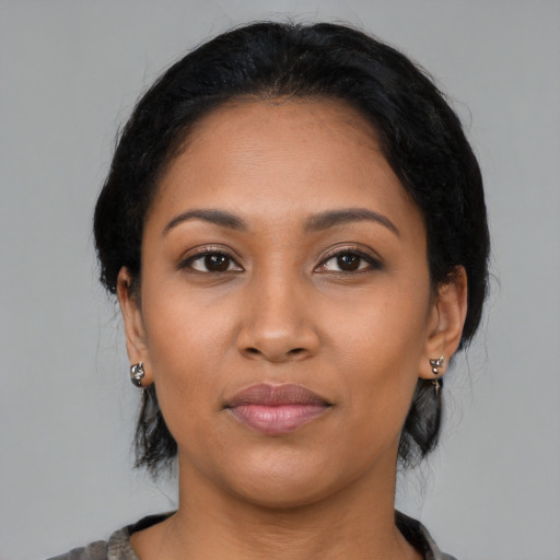 Joyful latino young-adult female with medium  black hair and brown eyes
