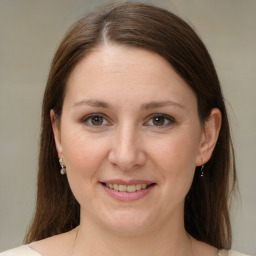 Joyful white young-adult female with medium  brown hair and grey eyes