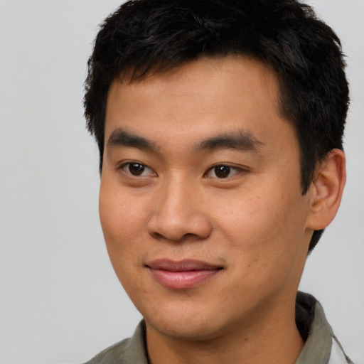 Joyful asian young-adult male with short  brown hair and brown eyes