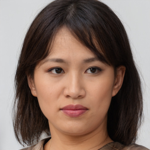 Neutral asian young-adult female with medium  brown hair and brown eyes