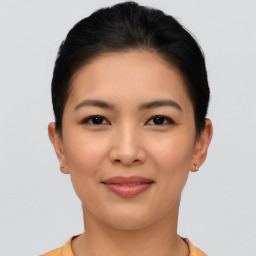 Joyful asian young-adult female with short  brown hair and brown eyes