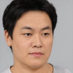 Neutral asian young-adult male with short  brown hair and brown eyes