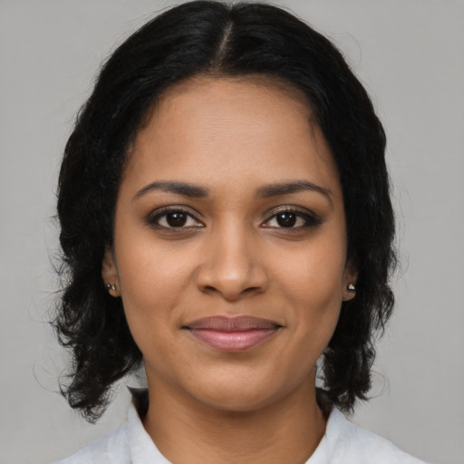 Joyful black young-adult female with medium  black hair and brown eyes