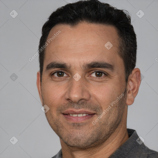 Joyful white adult male with short  black hair and brown eyes