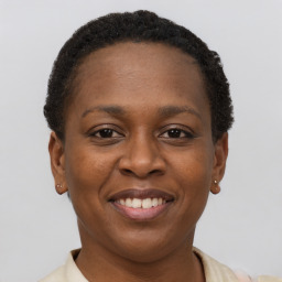 Joyful black young-adult female with short  brown hair and brown eyes