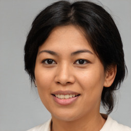 Joyful asian young-adult female with medium  brown hair and brown eyes