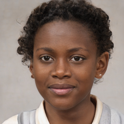 Joyful black child female with short  brown hair and brown eyes