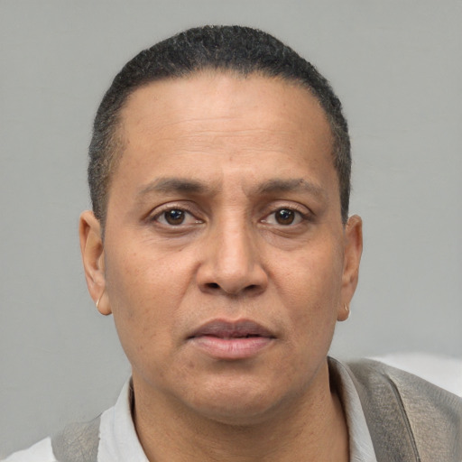 Neutral latino adult male with short  brown hair and brown eyes