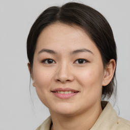 Joyful asian young-adult female with medium  brown hair and brown eyes