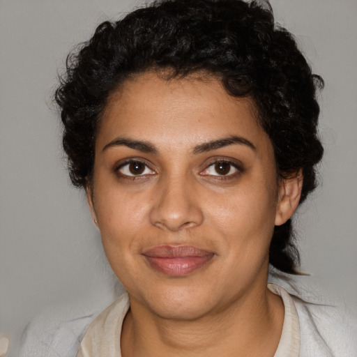 Joyful black young-adult female with medium  brown hair and brown eyes