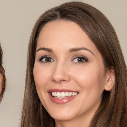 Joyful white young-adult female with long  brown hair and brown eyes