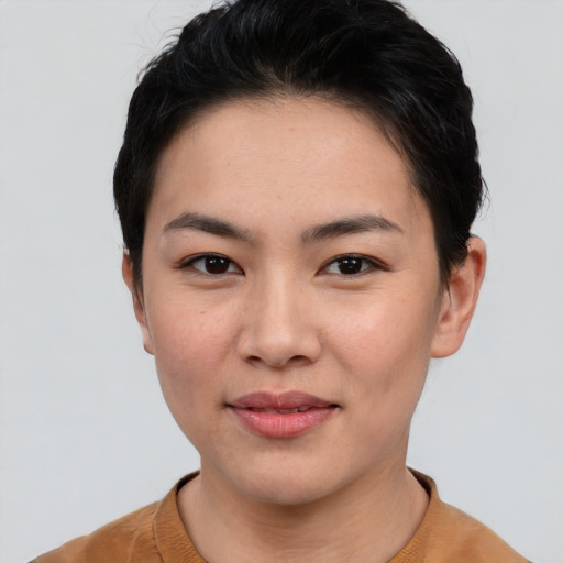 Joyful asian young-adult female with short  black hair and brown eyes