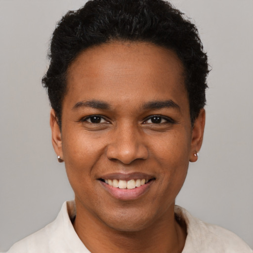 Joyful black young-adult female with short  black hair and brown eyes