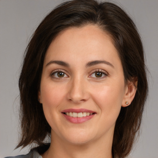 Joyful white young-adult female with medium  brown hair and brown eyes