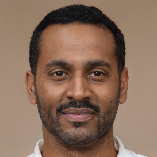 Neutral latino adult male with short  black hair and brown eyes