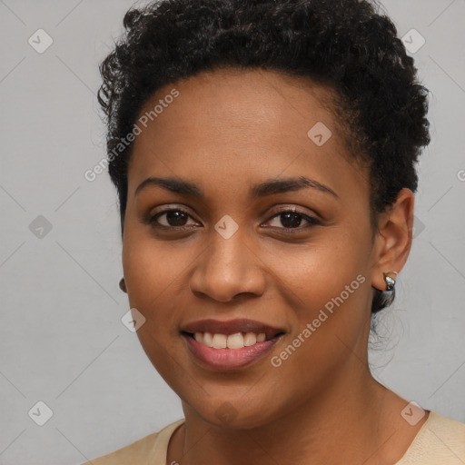 Joyful black young-adult female with short  black hair and brown eyes