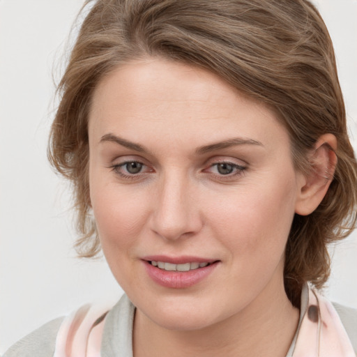 Joyful white young-adult female with medium  brown hair and blue eyes