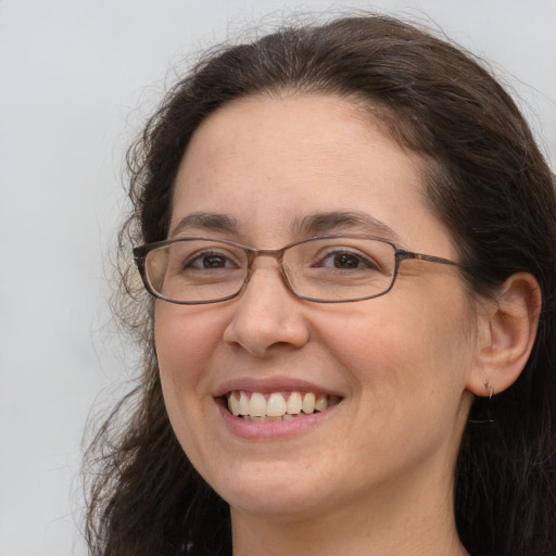 Joyful white adult female with long  brown hair and brown eyes