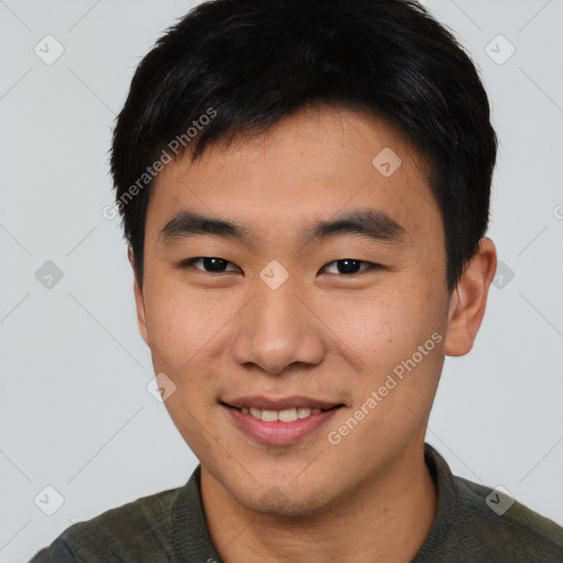 Joyful asian young-adult male with short  black hair and brown eyes