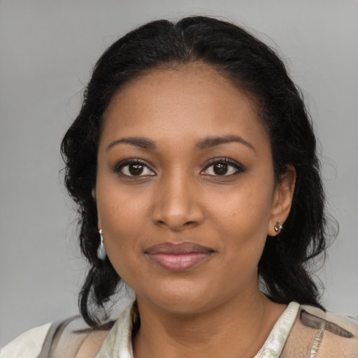 Joyful black young-adult female with medium  black hair and brown eyes